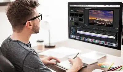 Video editor working on a timeline at a desktop workstation